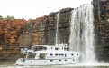 a large waterfall in front of a building