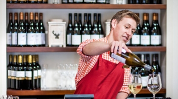 a person holding a bottle of wine