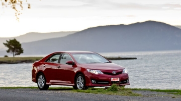 a car parked in front of a body of water