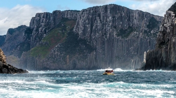 a man riding a wave on top of a mountain