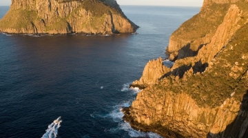 a rocky island in the middle of a body of water