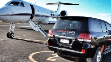 a small plane sitting on top of a car