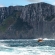 a man riding a wave on top of a mountain