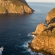 a rocky island in the middle of a body of water