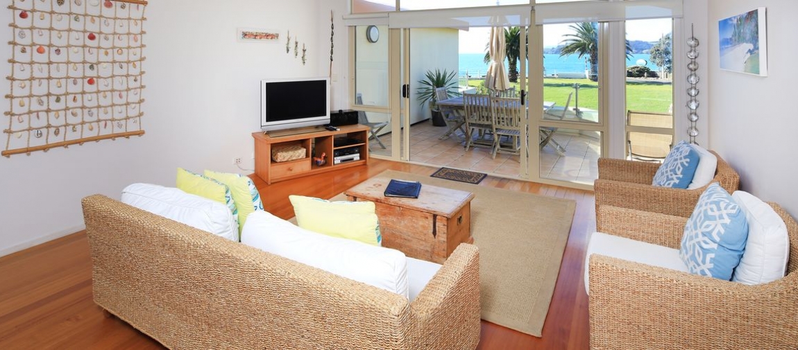 a living room filled with furniture and a bed
