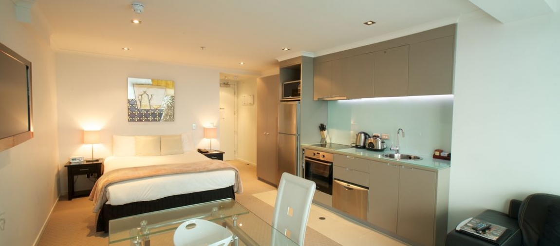 a hotel room with a sink and a mirror
