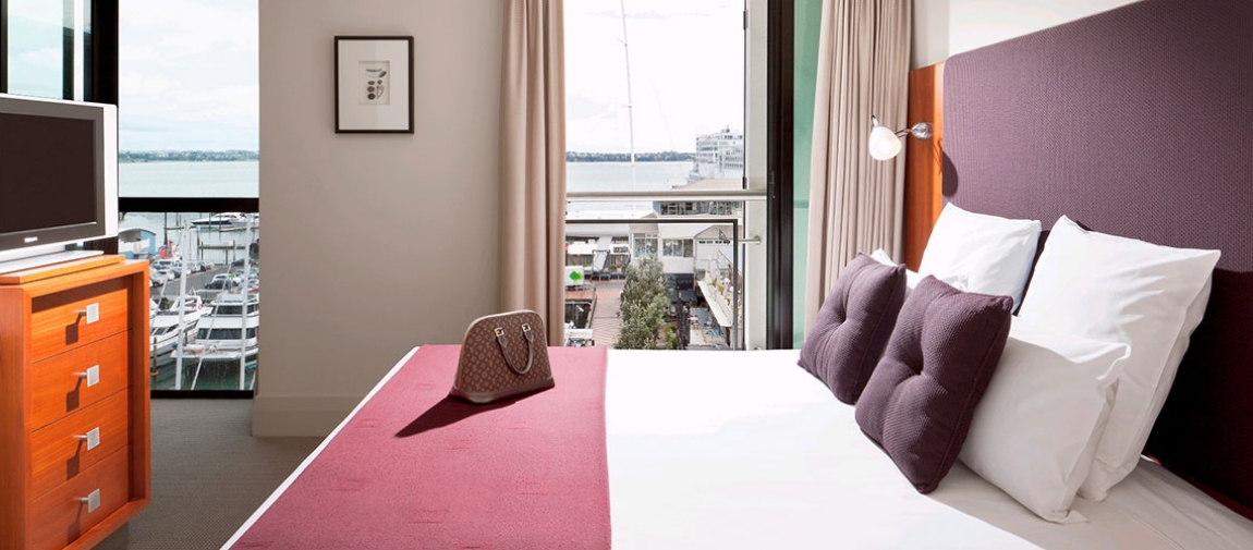 a living room with a bed and a window