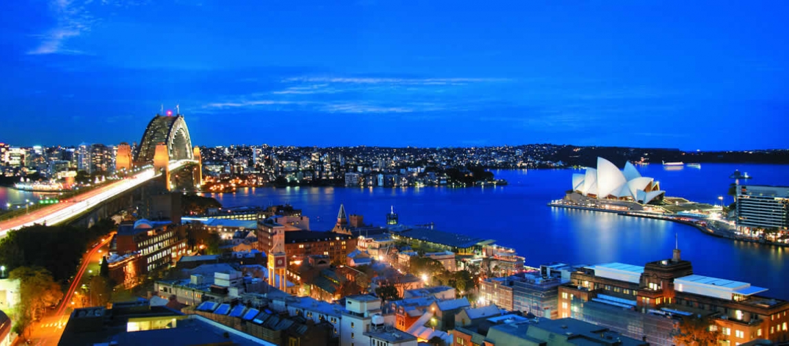 a large body of water with a city in the background