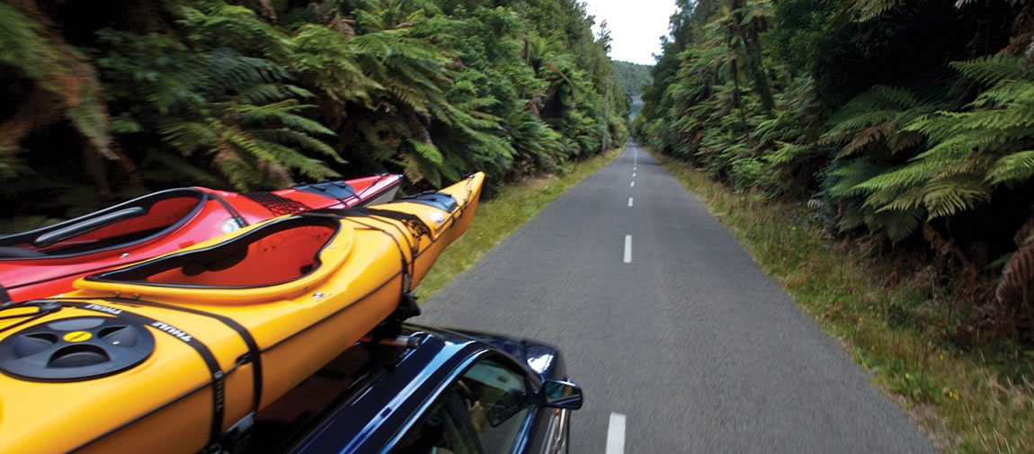 a yellow car parked on the side of a road