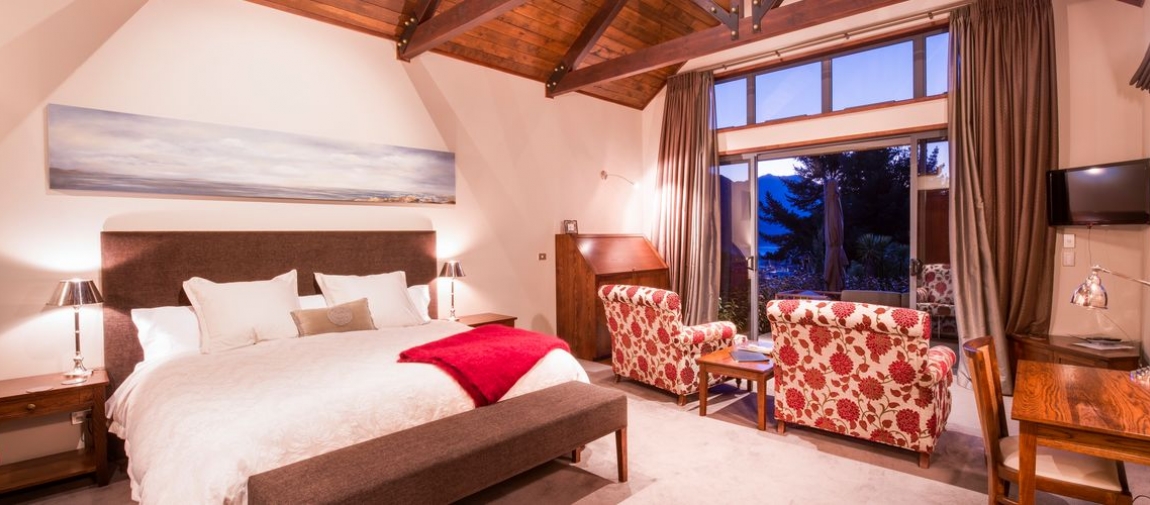 a bedroom with a large red chair in a room