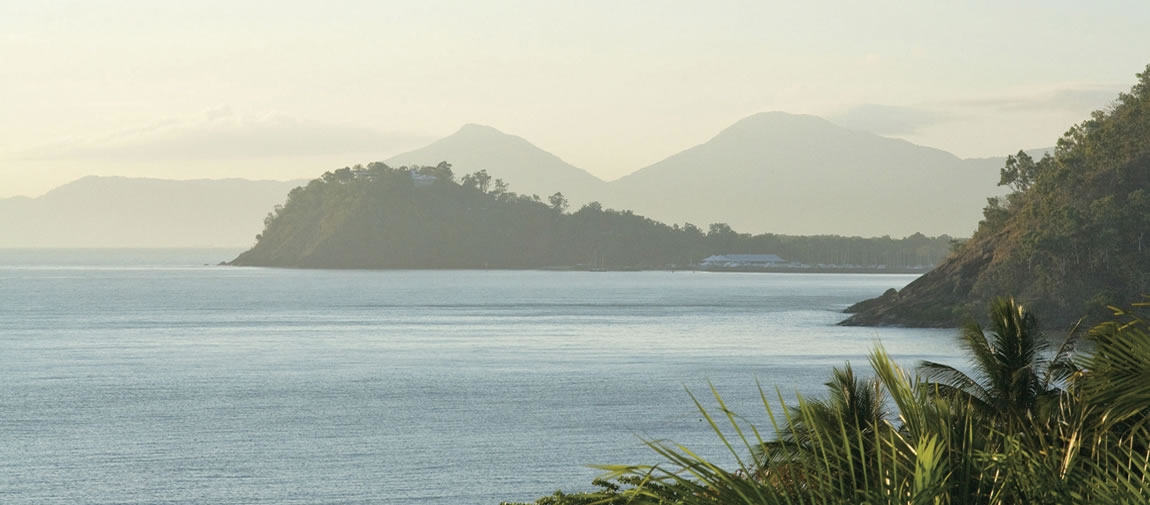 a body of water with a mountain in the background