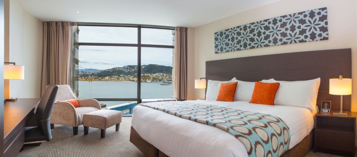 a bedroom with a large bed in a hotel room