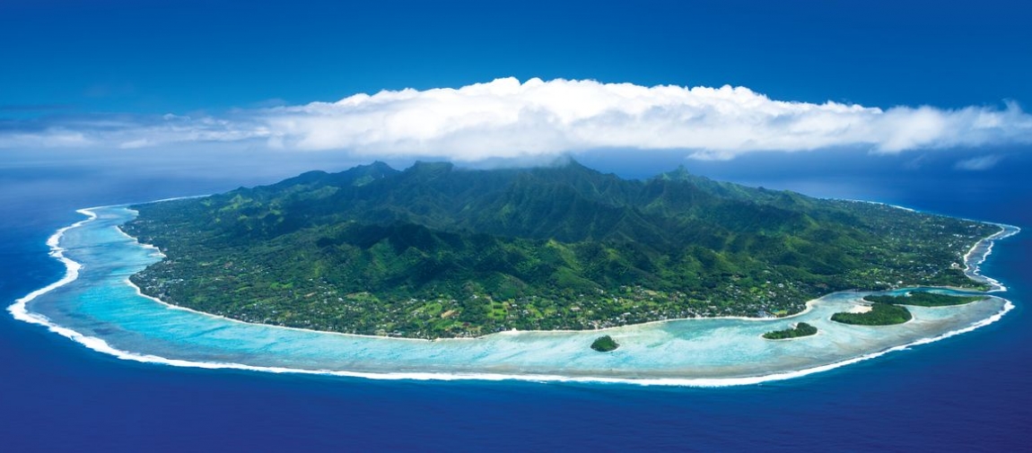 an island in the middle of a body of water with Rarotonga in the background