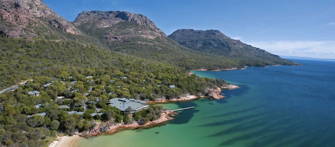 a large body of water with a mountain in the background