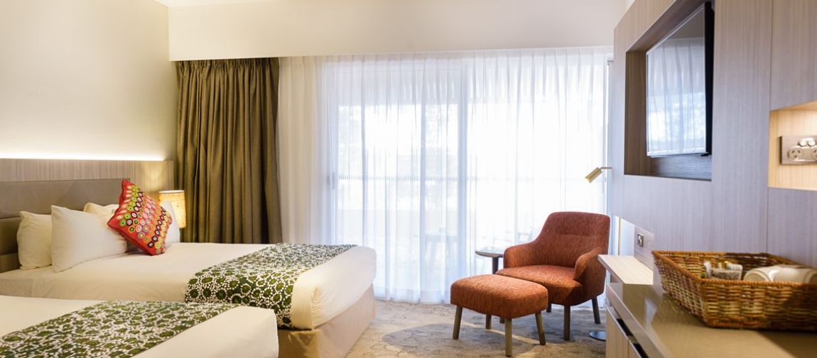 a hotel room filled with furniture and a large window