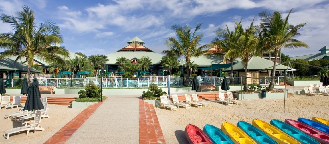 a group of lawn chairs sitting on top of a beach