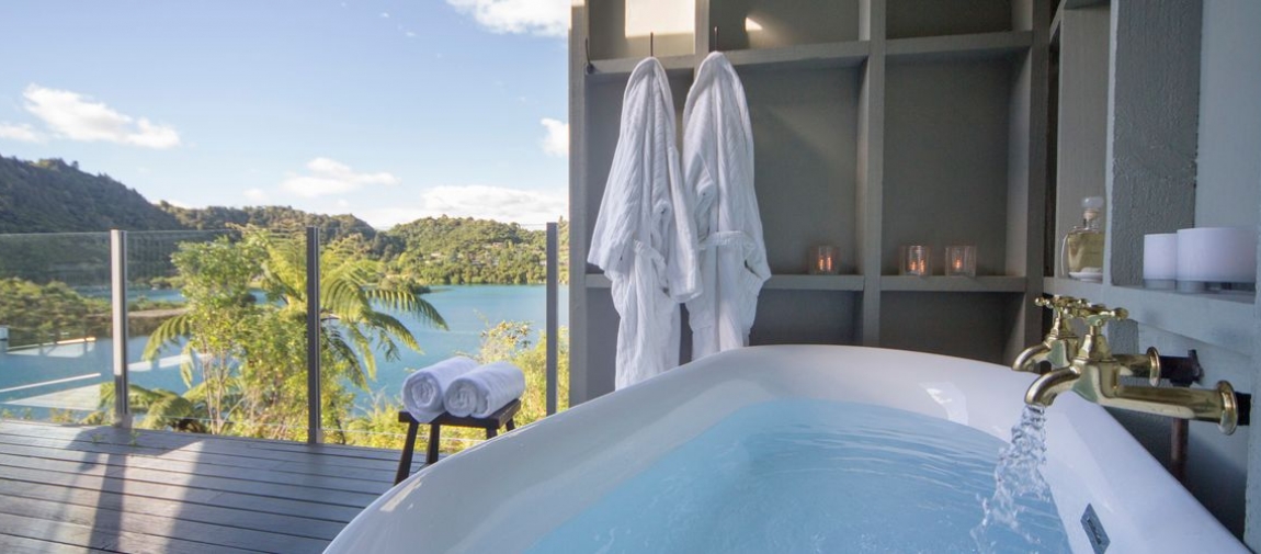 a large white tub sitting next to a window