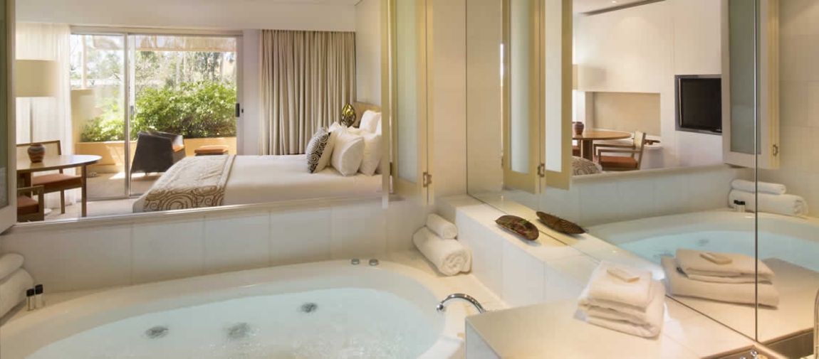 a large white tub sitting next to a sink