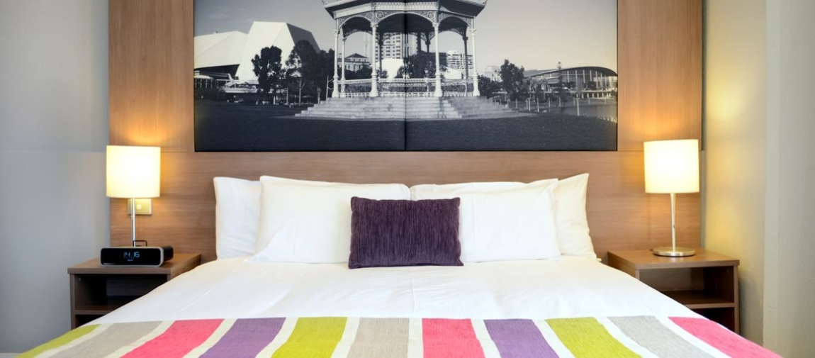 a bedroom with a large bed in a hotel room