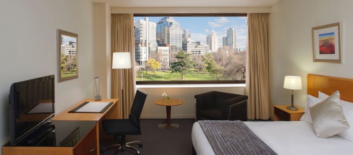 a hotel room with a desk and chair