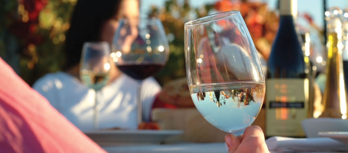 a hand holding a glass of wine