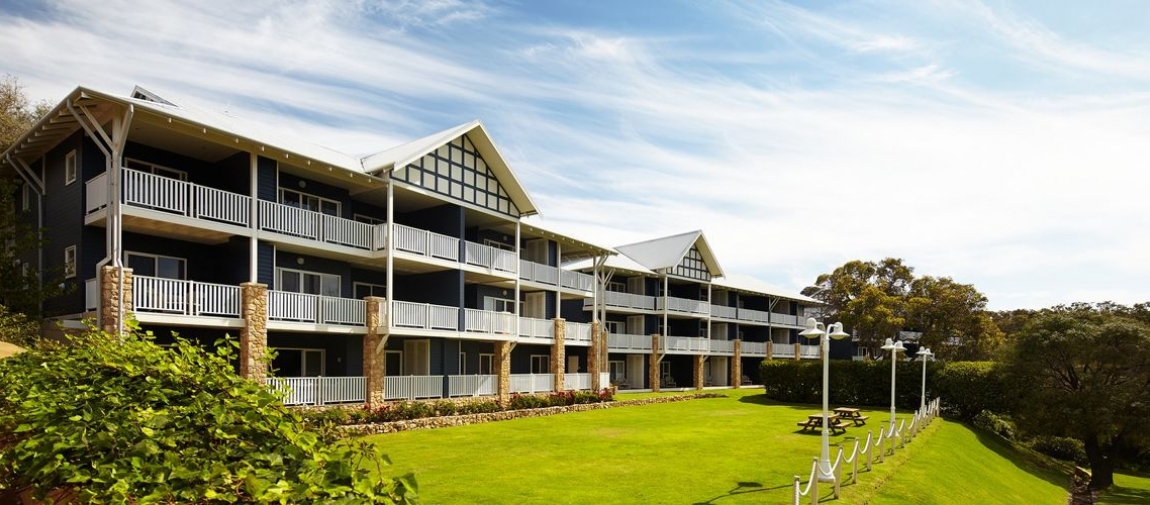 a large building with a grassy field