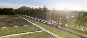 a long train traveling along side of a road