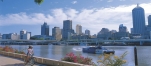 a bridge over a body of water with a city in the background