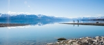 a large body of water with a mountain in the background