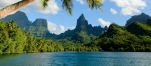 a large body of water with a mountain in the background