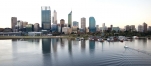 a body of water with a city in the background