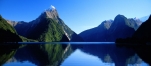 a body of water with Milford Sound in the background