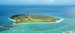 an island in the middle of a body of water with Lady Elliot Island in the background