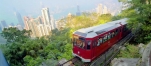 a red and white train traveling through a city