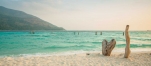 a sandy beach next to a body of water