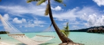 a boat sitting on top of a sandy beach