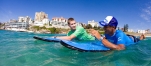 a young boy swimming in blue water