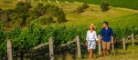 a person that is standing in the grass near a fence