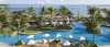 a group of palm trees next to a pool of water