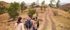 a man and a boy walking down a dirt road