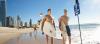 a couple of people that are standing in the sand on a beach