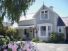 a close up of a flower garden in front of a house