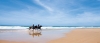 a person riding a horse on a beach