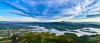 a large body of water with a mountain in the background