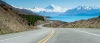 an empty road with a mountain in the background