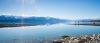 a large body of water with a mountain in the background