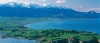 a large body of water with a mountain in the background