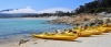 a boat sitting on top of a sandy beach