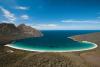 a beach with a mountain in the background