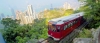 a red and white train traveling through a city